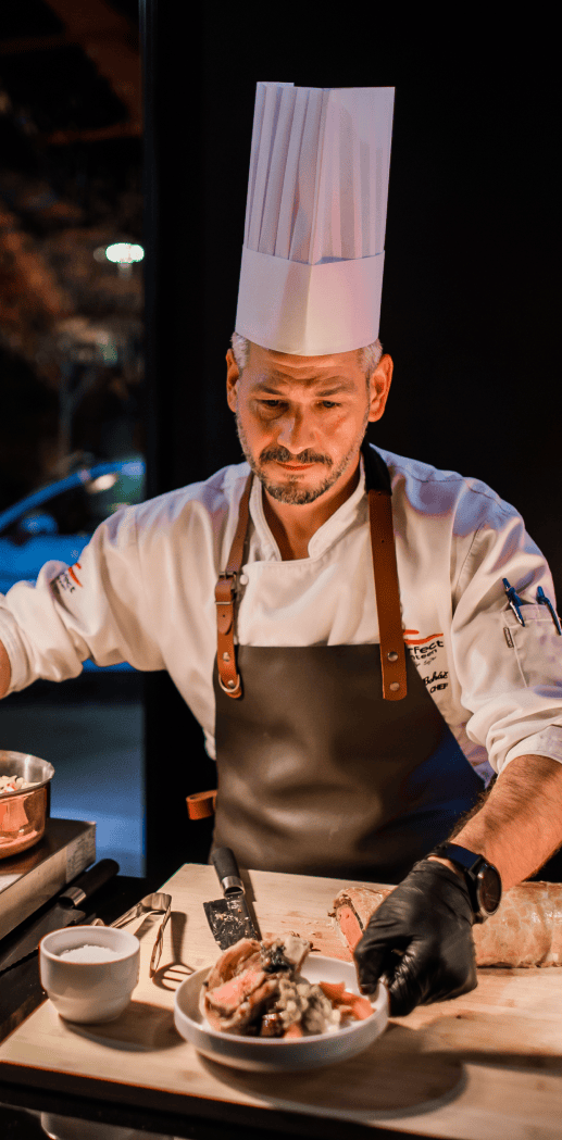 Head chef finishing a dish for guests