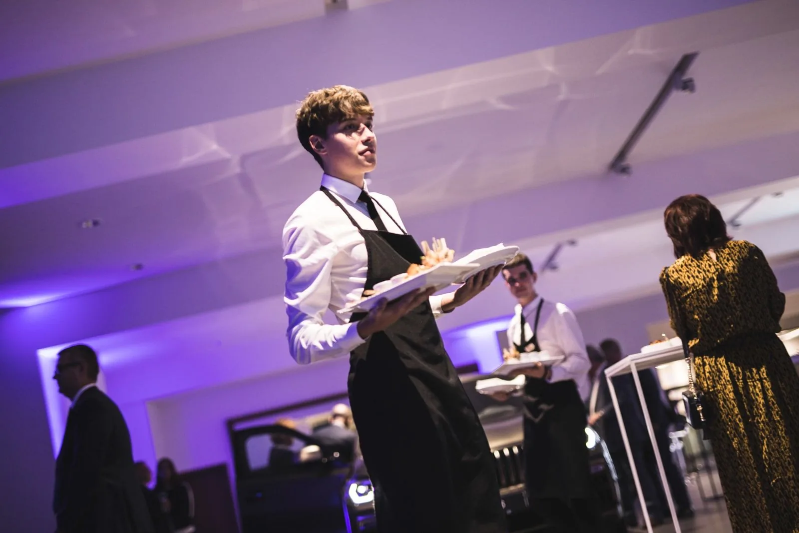 Service team member serving drinks at an event