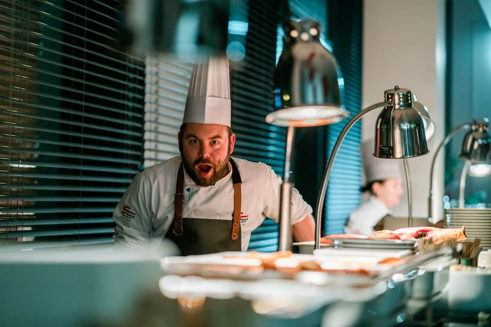 Head chef finishing a dish at the pass