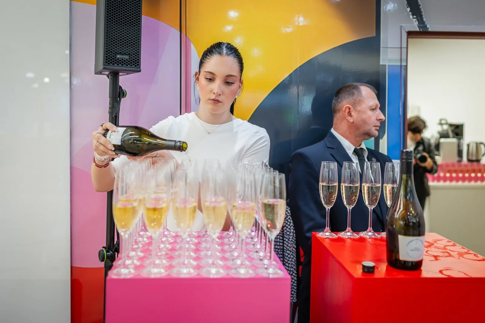 Bartender preparing colourful cocktails for guests