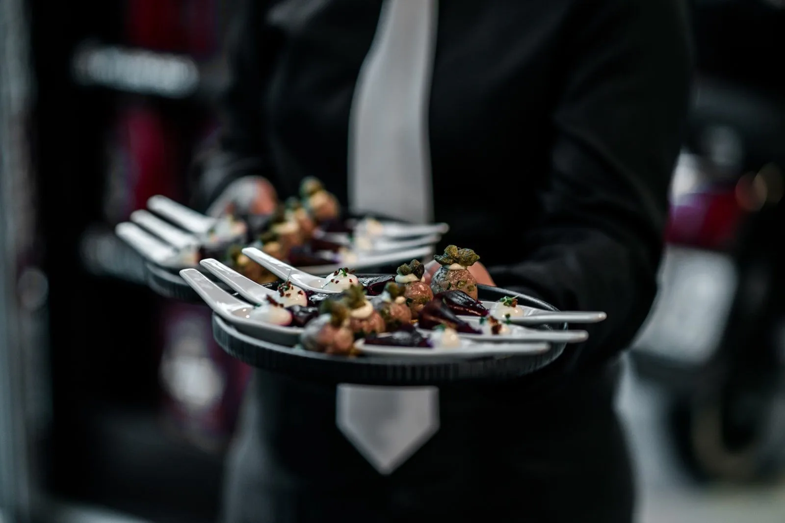 Waiter carrying a tray of finger food