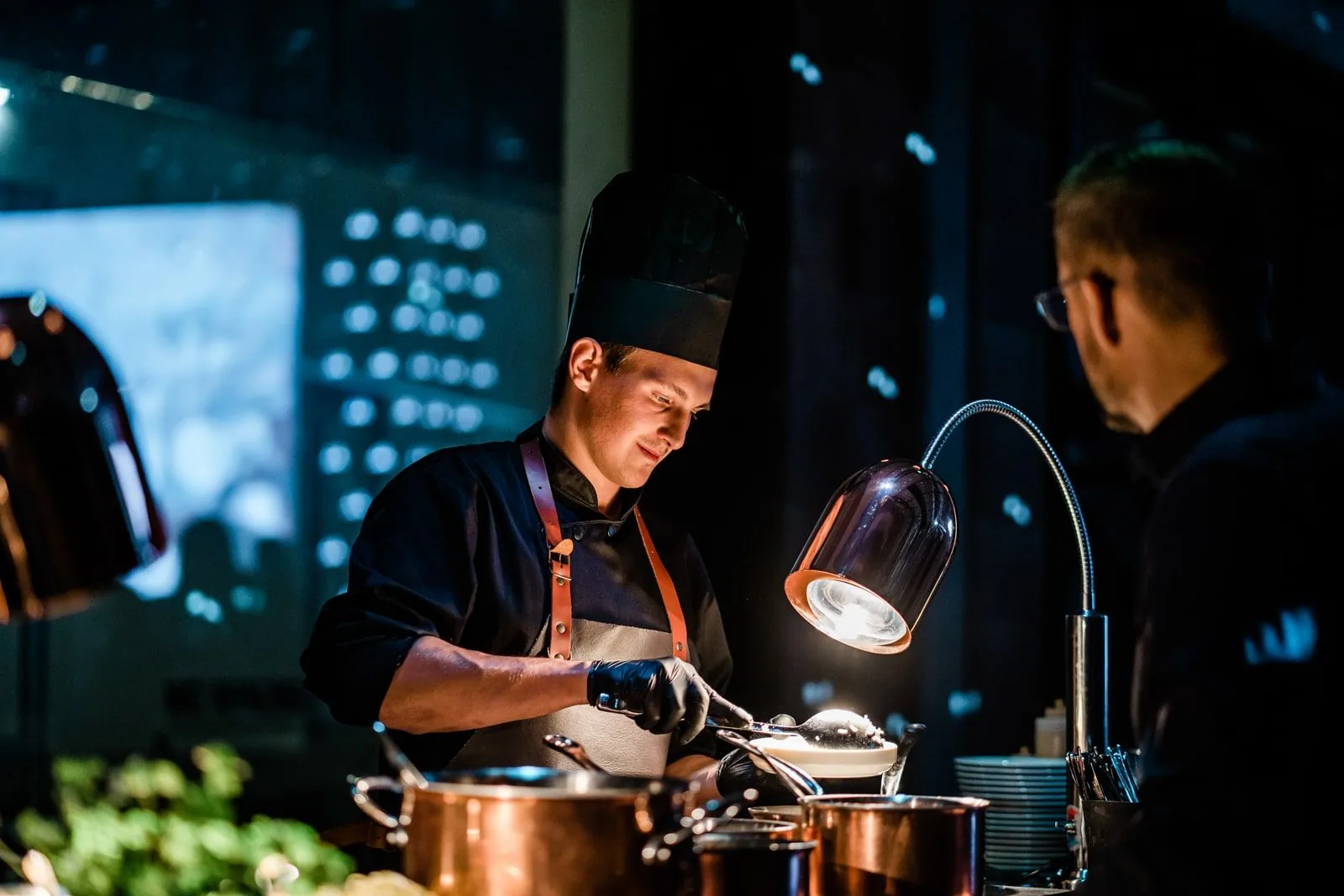 Chef preparing food at a live cooking station